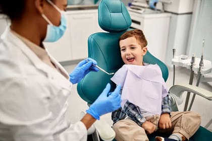 Pediatric dentist comforting an anxious child at Harmony Dental Clinic Jumeirah Dubai