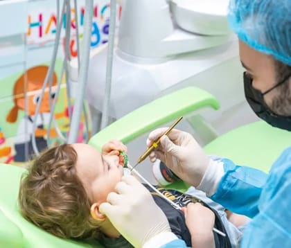 Pediatric dentist helping an anxious child feel calm at Harmony Dental Clinic Jumeirah Dubai