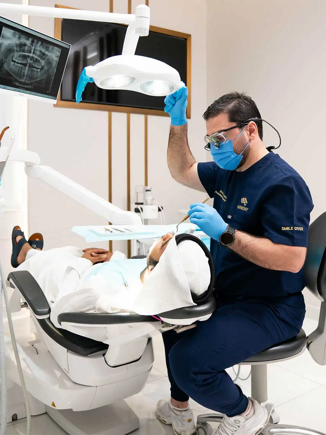 Photo of Dr. Mohammad Al Kowatly, Specialist Periodontist and Implantologist at Harmony Medical Center, with a patient.