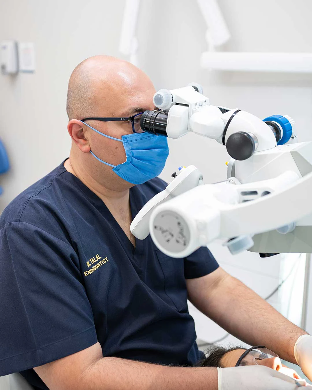 Dr. Talal Al Nahlawi, Head of the Endodontics Department at Harmony Medical Center, using a dental microscope to perform a root canal treatment (RCT).