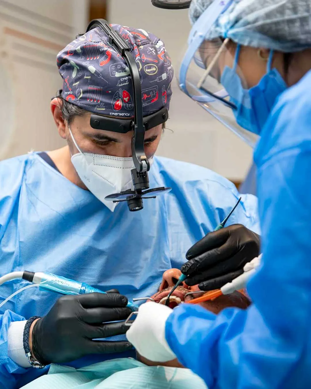A photo of  Dr. Ahmad Al Jazairi, Harmony Medical Center's Head Oral & Maxillofacial Surgeon with a male patient.