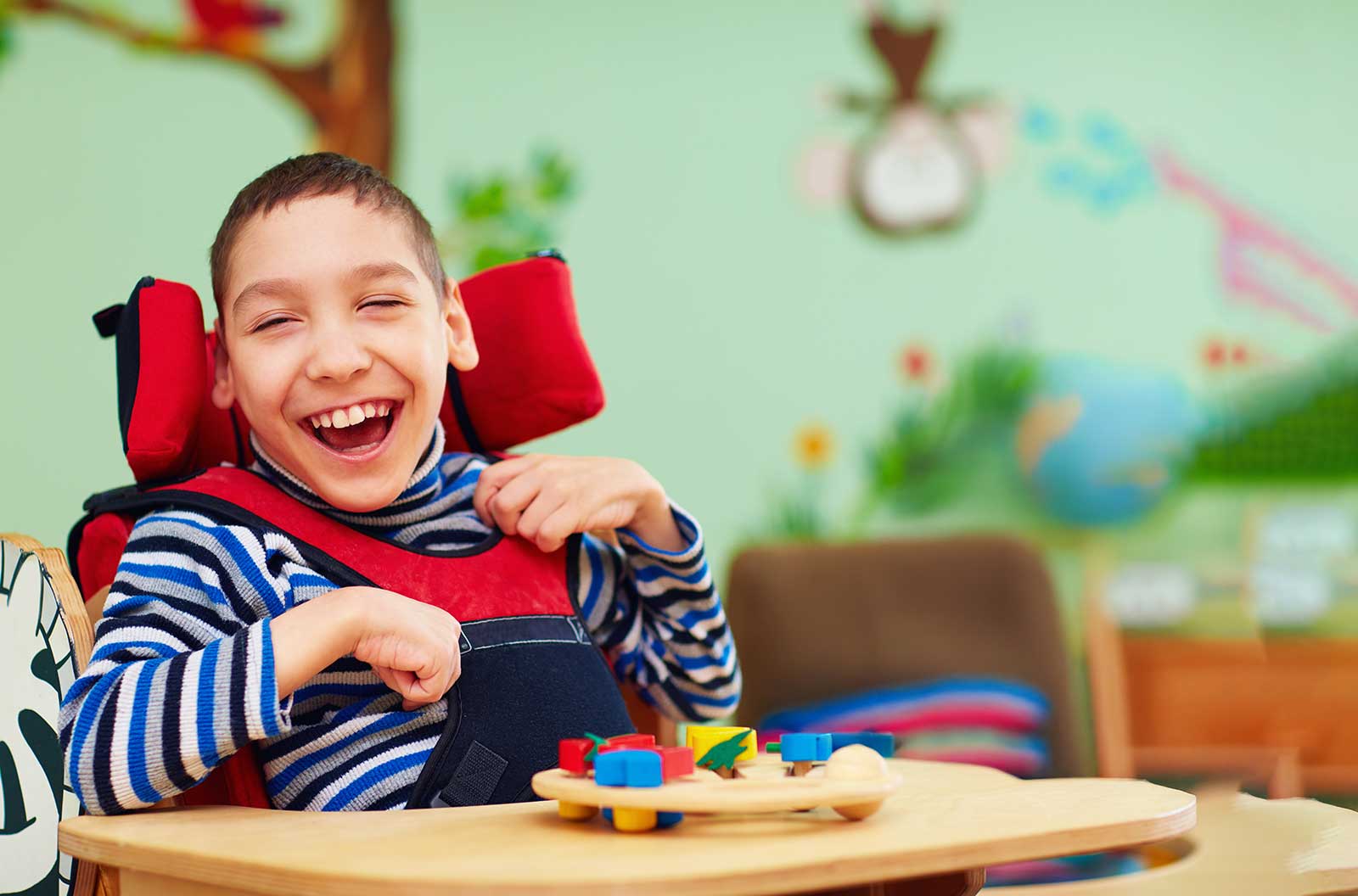 Child with special needs smiling during a gentle dental visit at Harmony Medical Center in Dubai